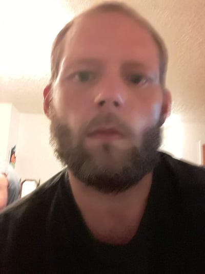 Image of man in black t-shirt as Avenues Recovery shares AJ's story