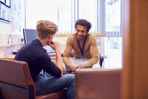 An addiction counselor guiding a patient in dealing with alcohol addiction
