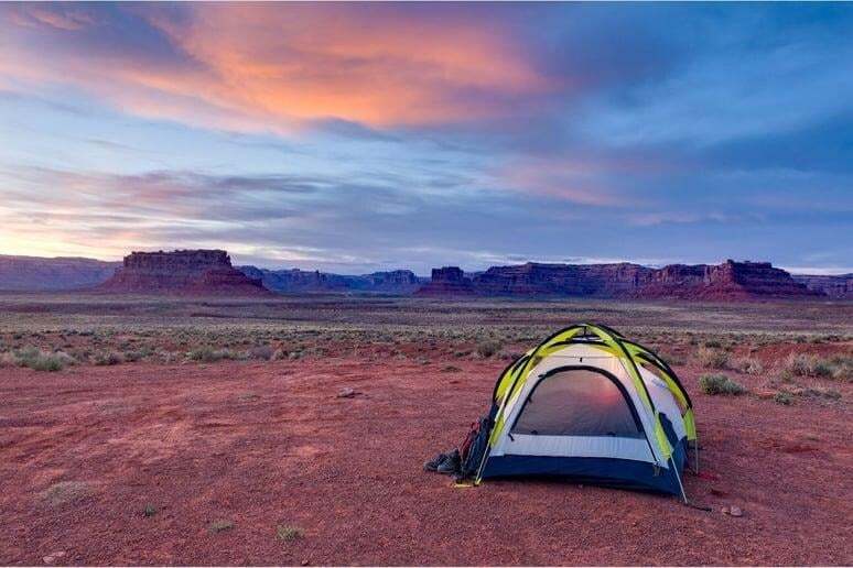 A tent in the desert of people taking part in adventure therapy for addiction