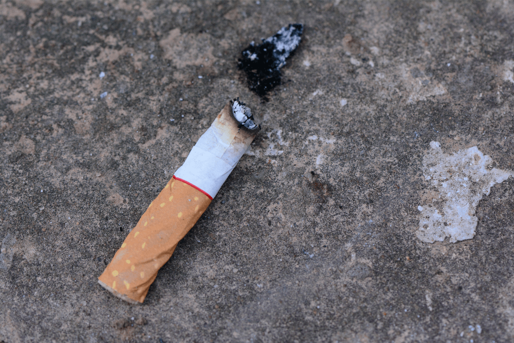 Used cigarette lying on the ground. Is your smoking a habit or an addiction?