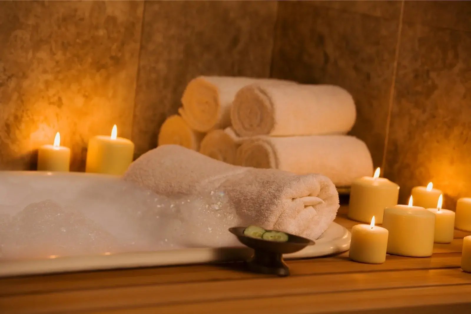 Bubble bath and candles show a good way to use essential oils for addiction recovery support.