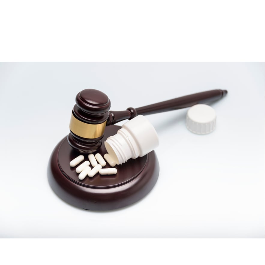 Judge’s gavel and pill bottle. What is Benzofury’s legal status?