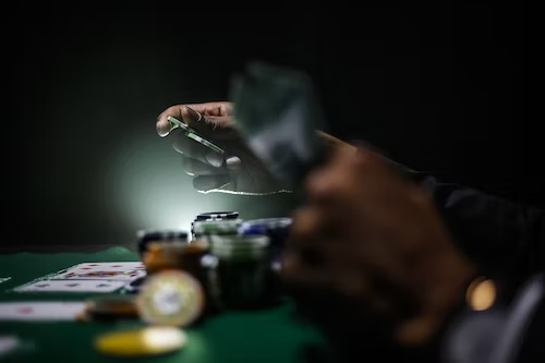 image of someone with gambling addiction handling gambling chips - Avenues Recovery