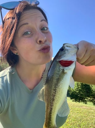 Image of woman holding fish as Avenues Recovery shares Hillary's story