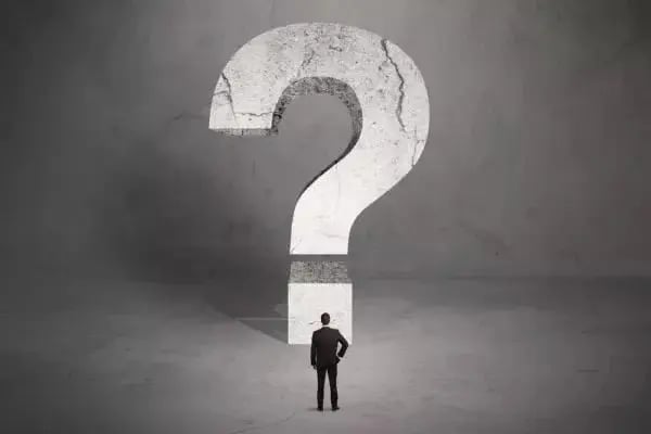 A man viewing a question mark. The disease model of addiction is still up for debate.