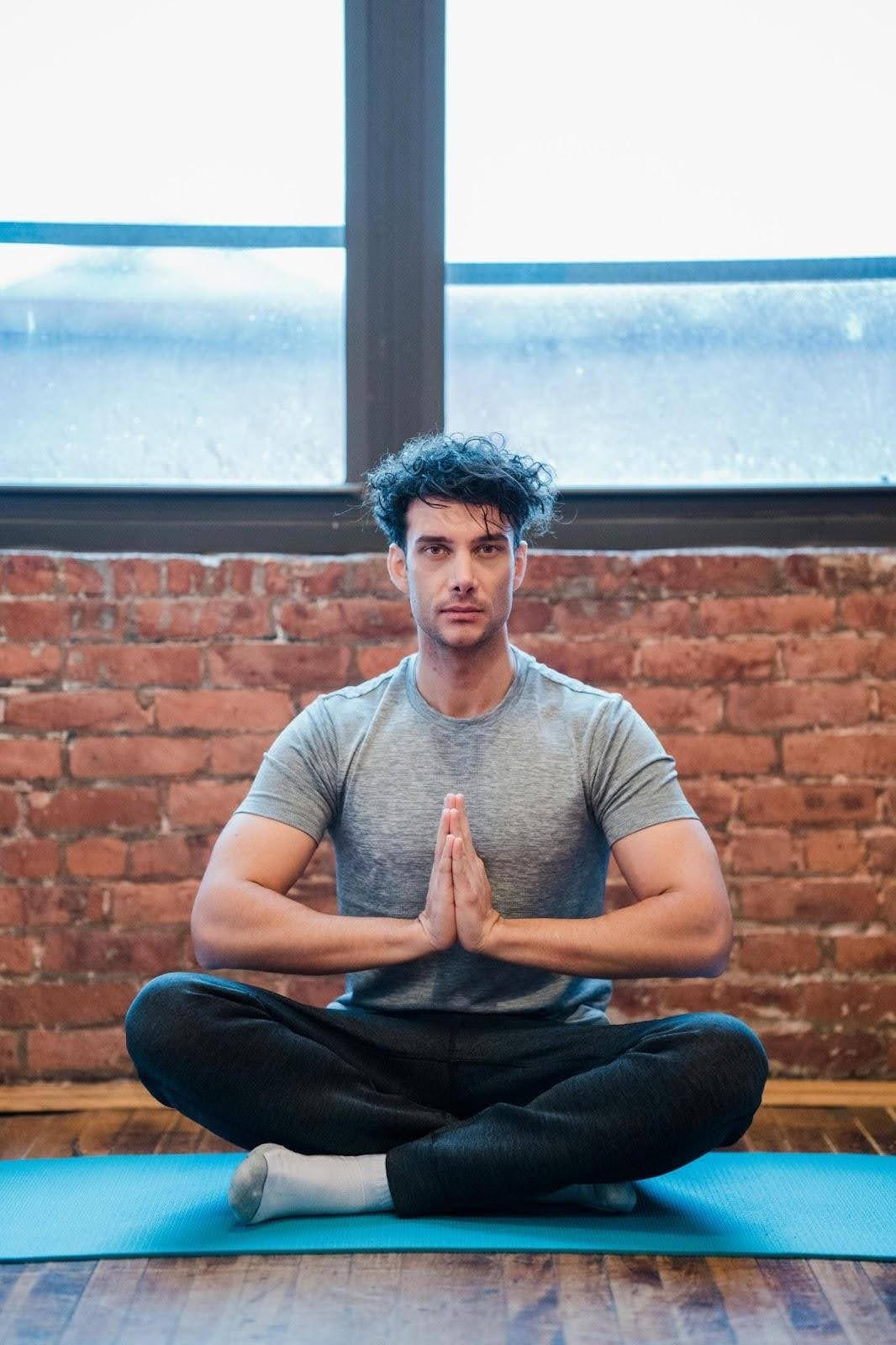 Man practicing meditation for overall recovery in a rehab facility that allows participants to smoke cigarettes.