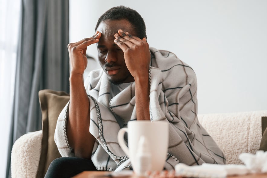 Individual showing common Adderall comedown symptoms such as headache, exhaustion, and mental strain.