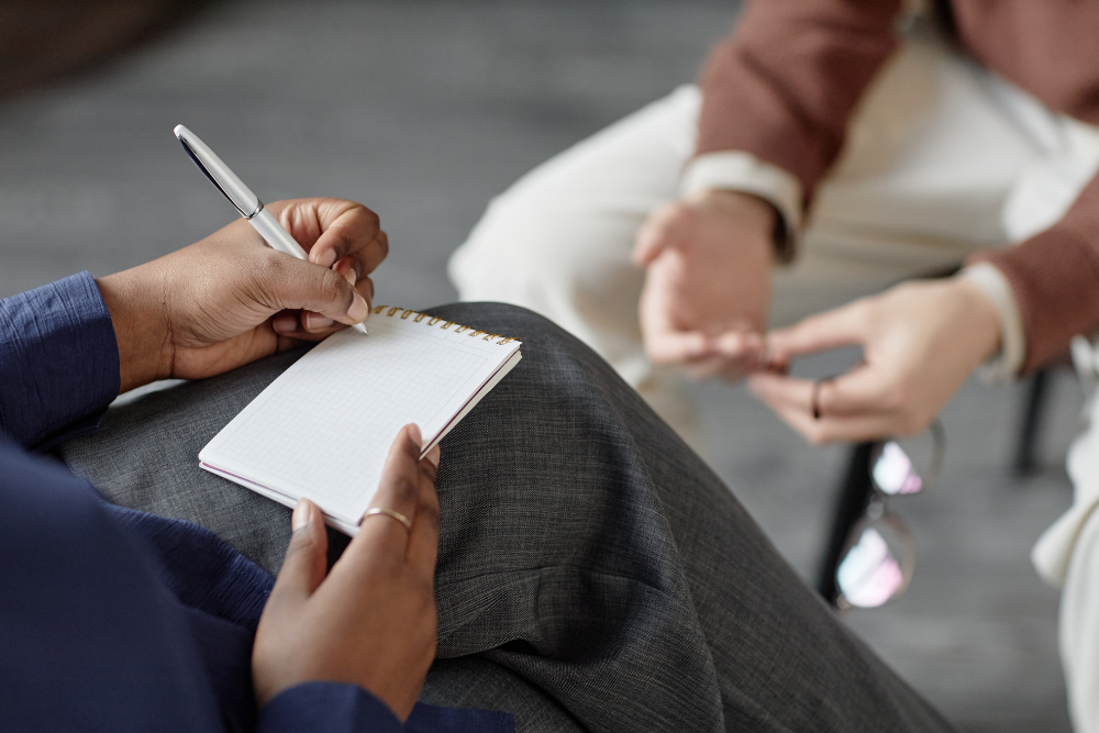 Healthcare professional documenting responses as part of a substance use evaluation.