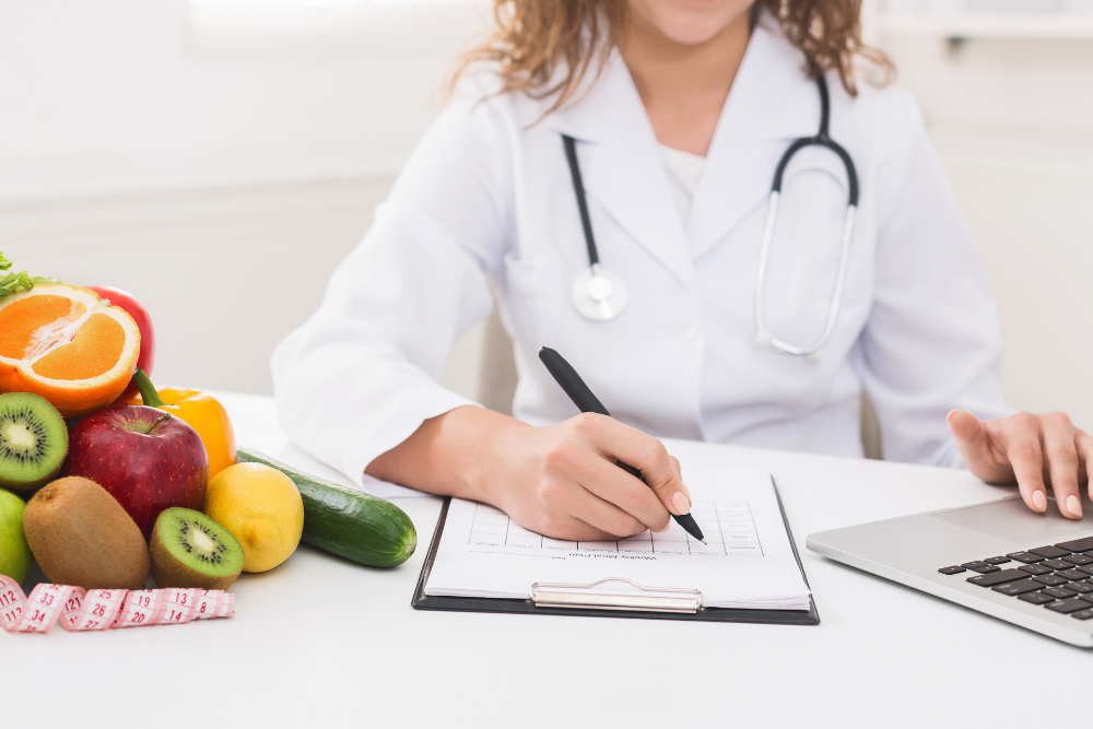 Nutritionist taking notes on her patient's sobriety diet plan, which will greatly impact their recovery trajectory