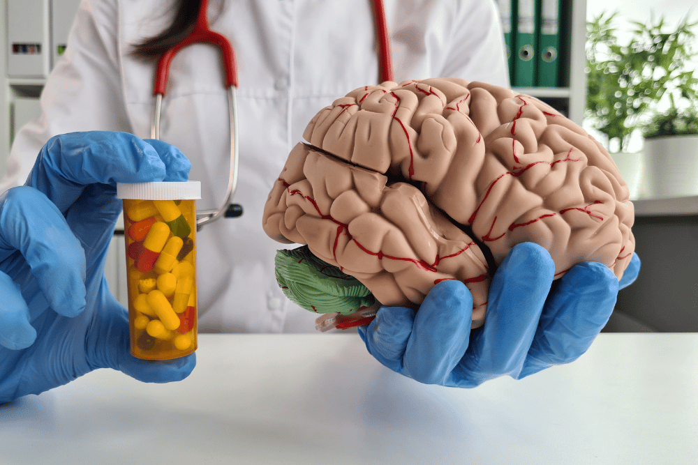 Conceptual image showing the brain and prescription medication to explain Adderall comedown effects.