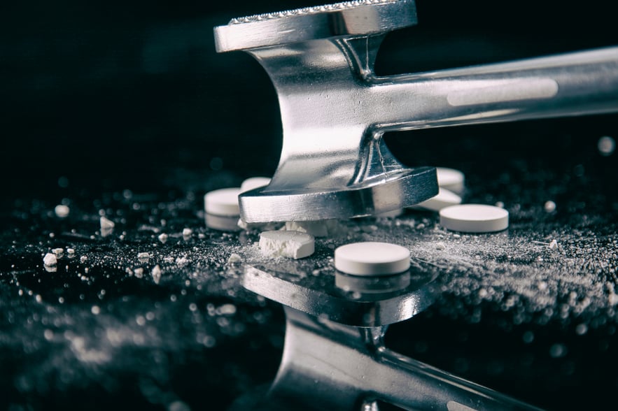 Crushed pills symbolizing the dangers of crushing Percocet for abuse.