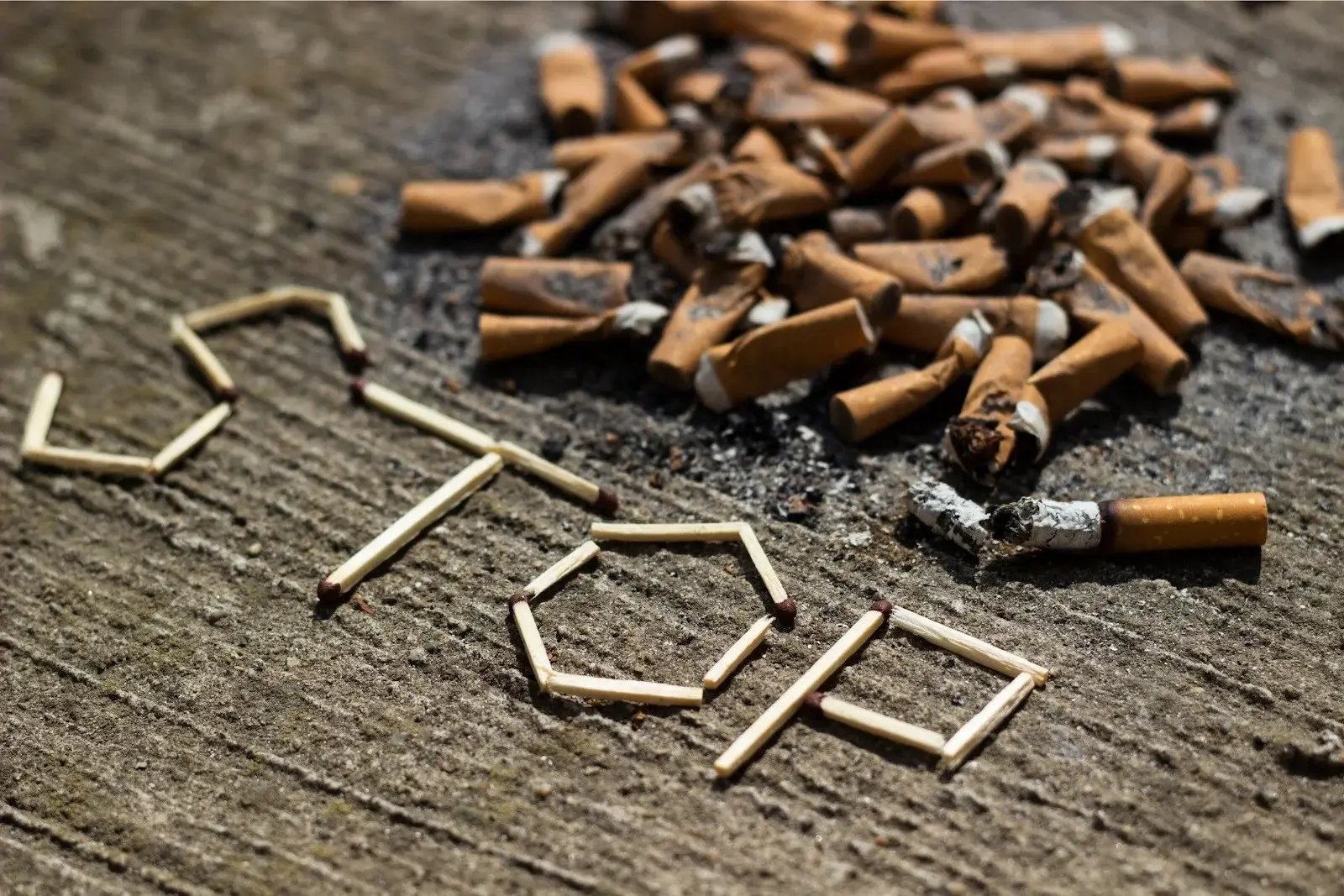 Matches forming ‘stop’ and cigarette butts. Essential oils for addiction can help you quit smoking.