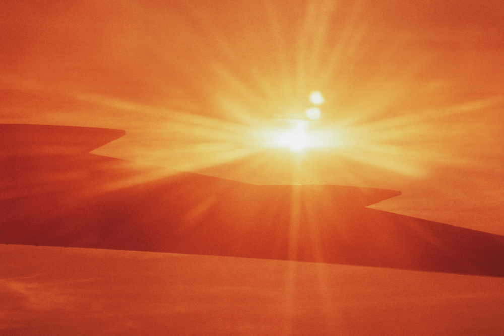 Bright sun rising on silhouetted fields and mountains. At Avenues Recovery, there is always hope.