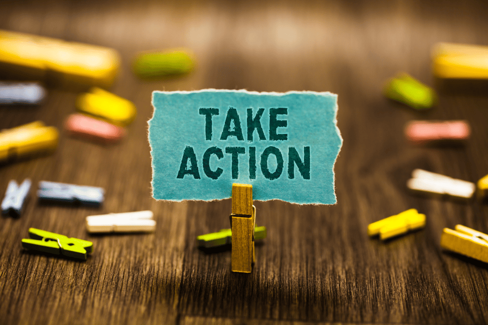 Peg holds note with text ‘Take Action’. CBT for addiction is action-oriented and practical.