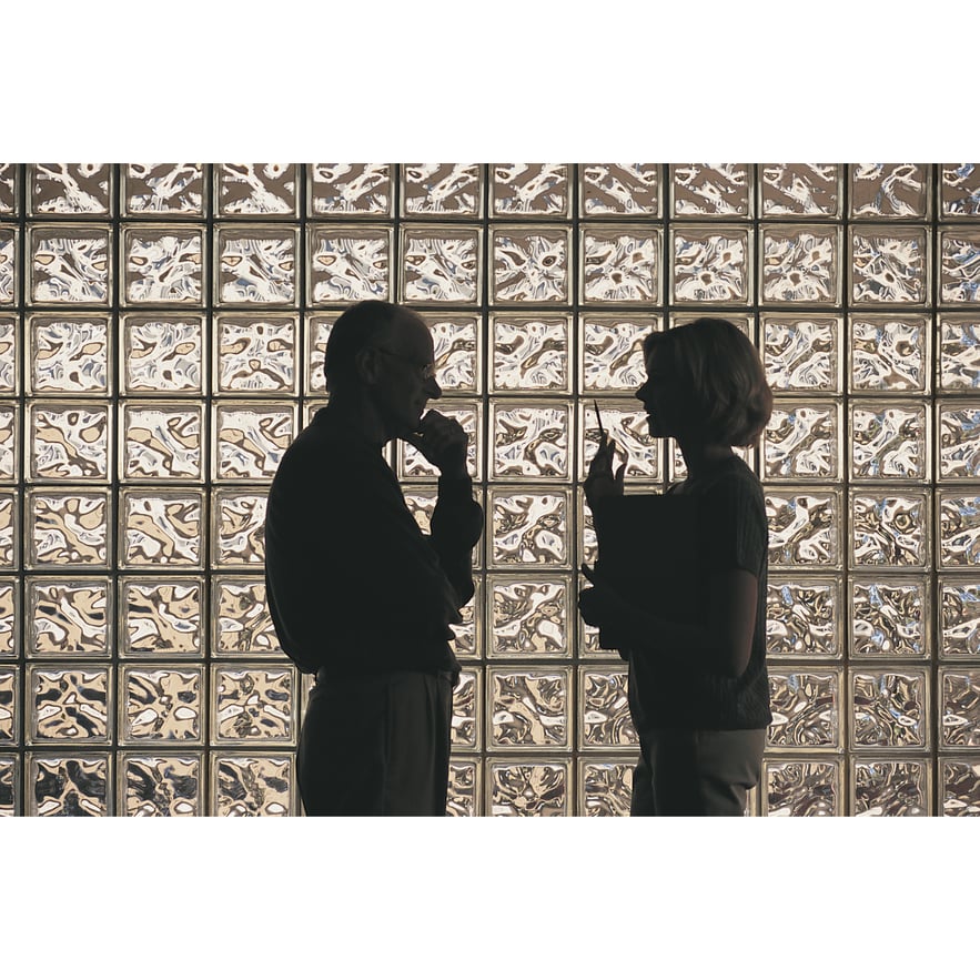 Silhouette of two people talking. Supportive communication helps when an addicted loved one lies.