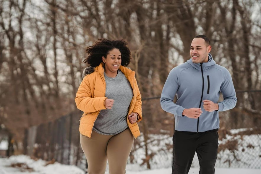 Two people jogging outdoors, experiencing the positive effects of quitting weed on their health