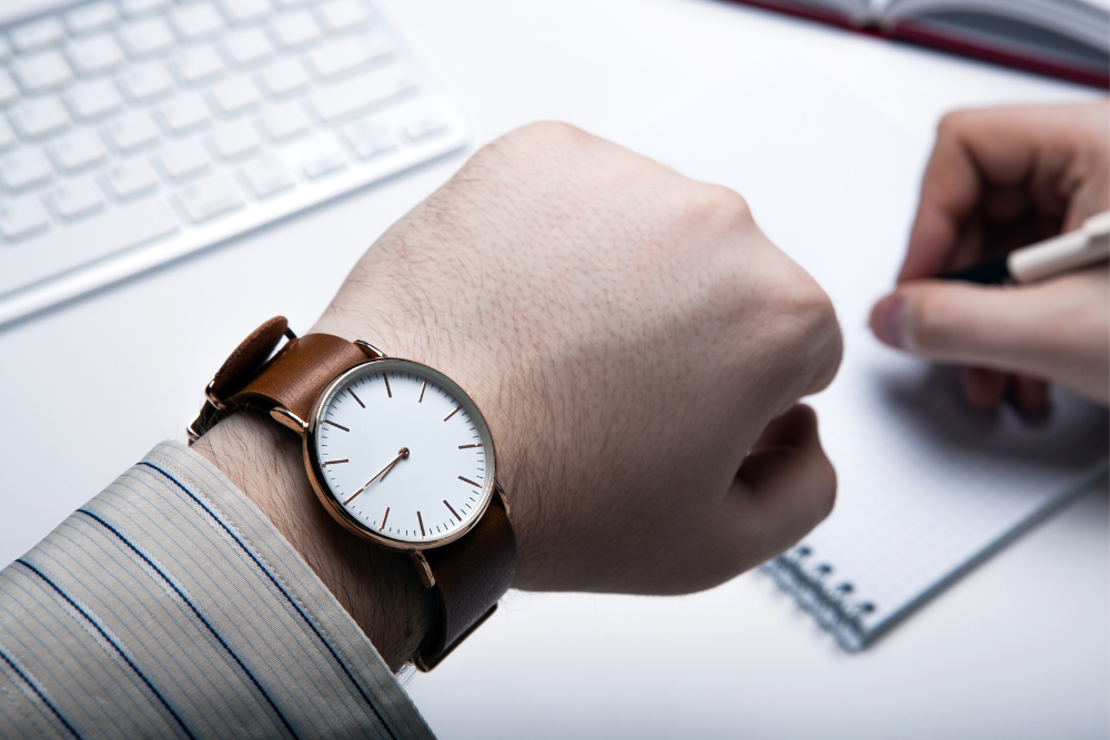 Close-up of a clinician checking time during a structured substance abuse assessment.