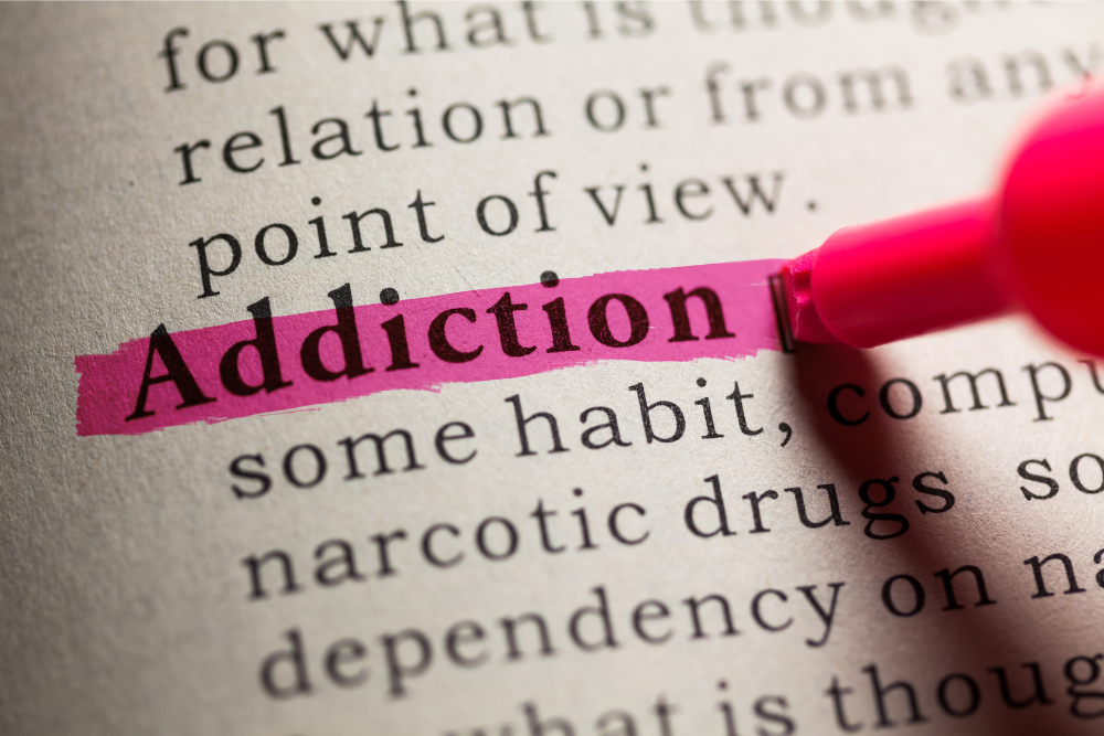 Word 'Addiction' highlighted in a book, representing growing awareness of Valium addiction