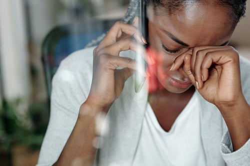 Image of distressed woman talking on phone as Avenues Recovery shares helpful Pennsylvania Crisis Helpline numbers