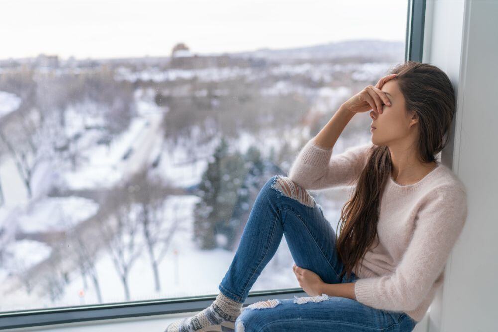 Woman suffering from depression and addiction, explained by Avenues Recovery.