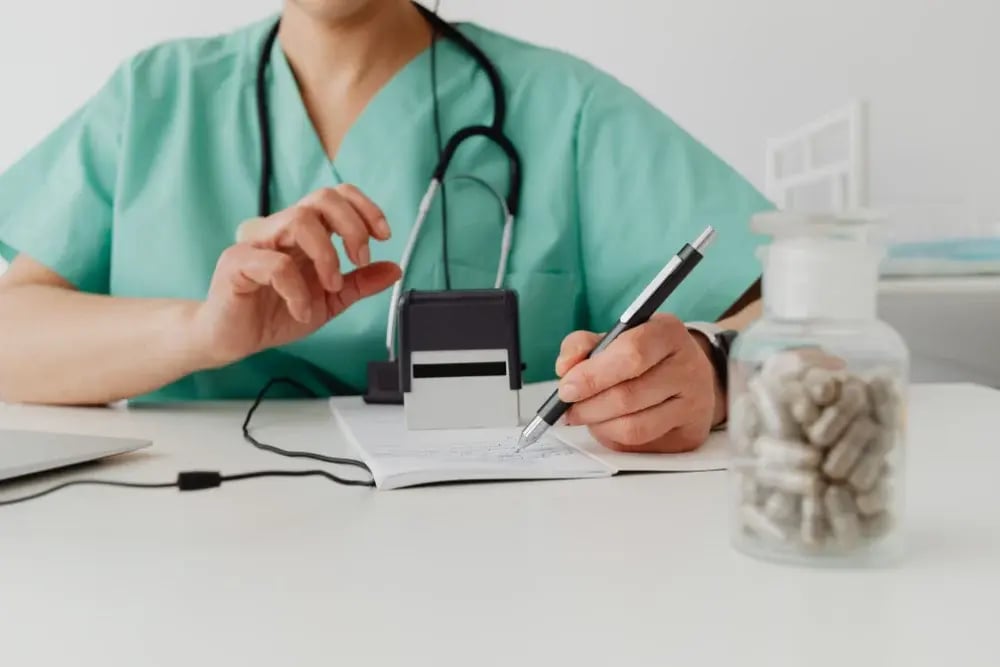 A physician writing out a prescription. Following doctor’s orders is crucial when taking dextroamphetamine or Adderall.