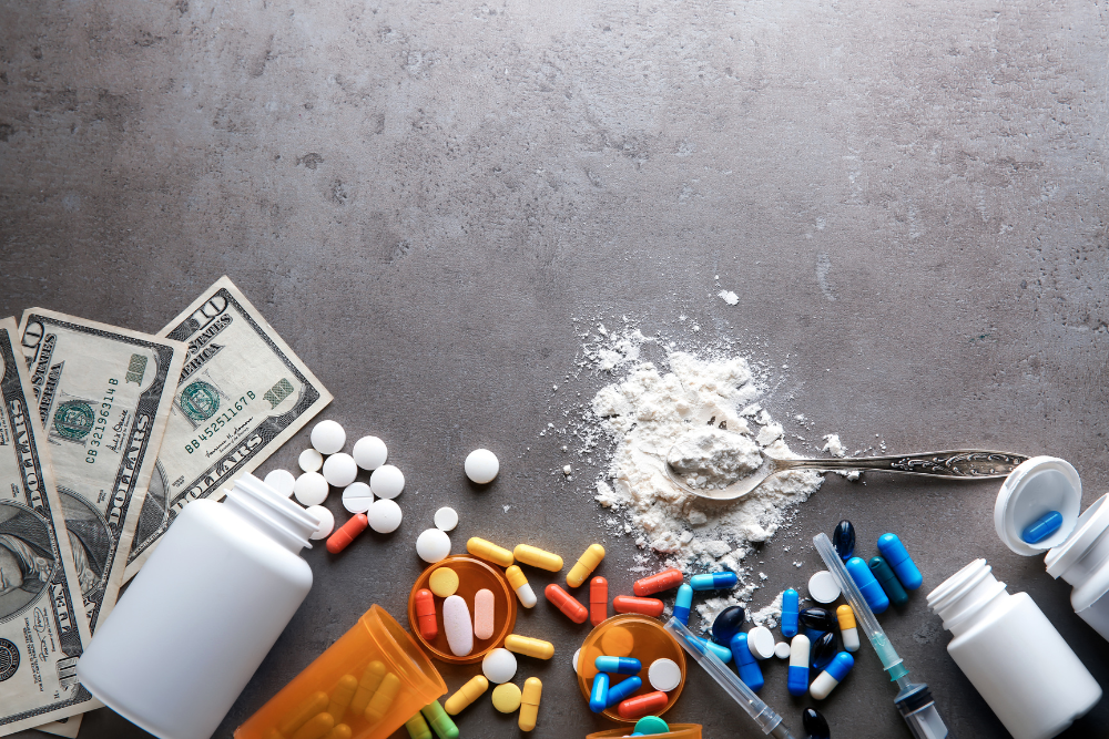 Assorted pills on table that, when combined, may affect how long Vyvanse remains in the body
