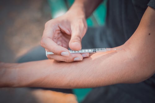 injecting drugs