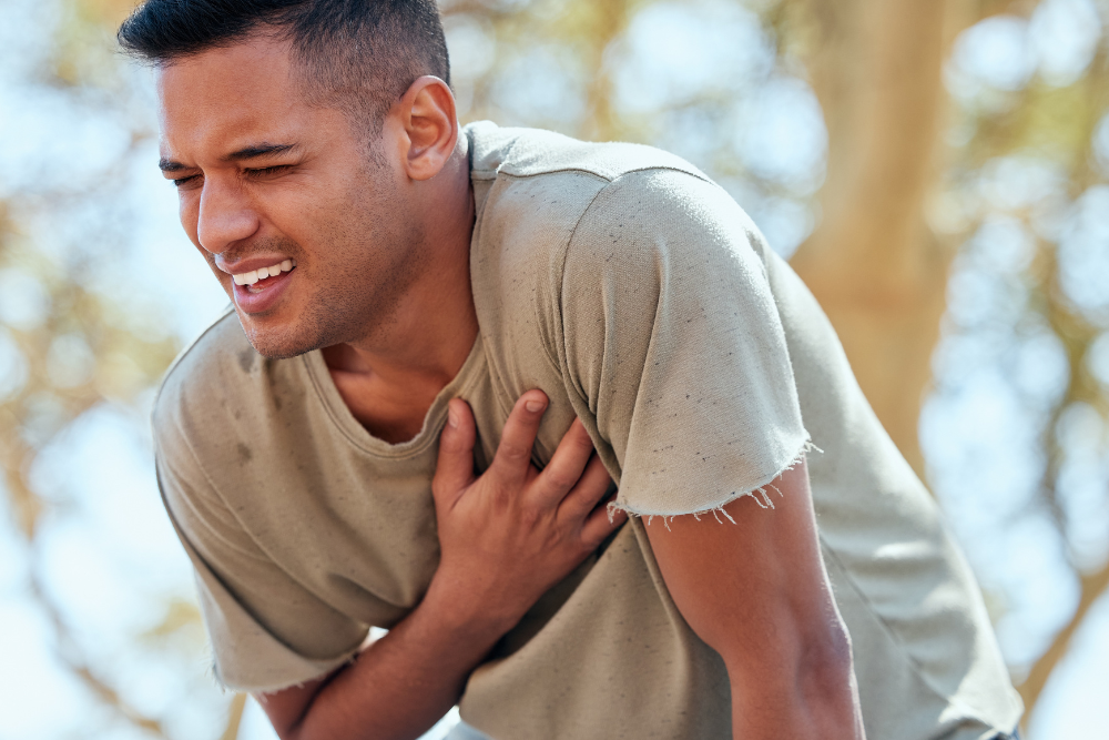Man clutching his heart, experiencing cardiac arrest after an untreated overdose of Wellbutrin (bupropion). Avenues Recovery