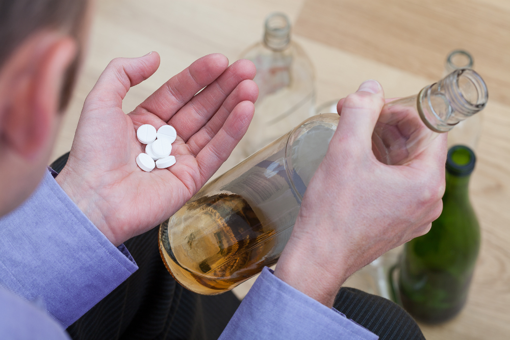 Man mixing lithium with alcohol, a dangerous combination that can lead to lithium toxicity. Avenues Recovery