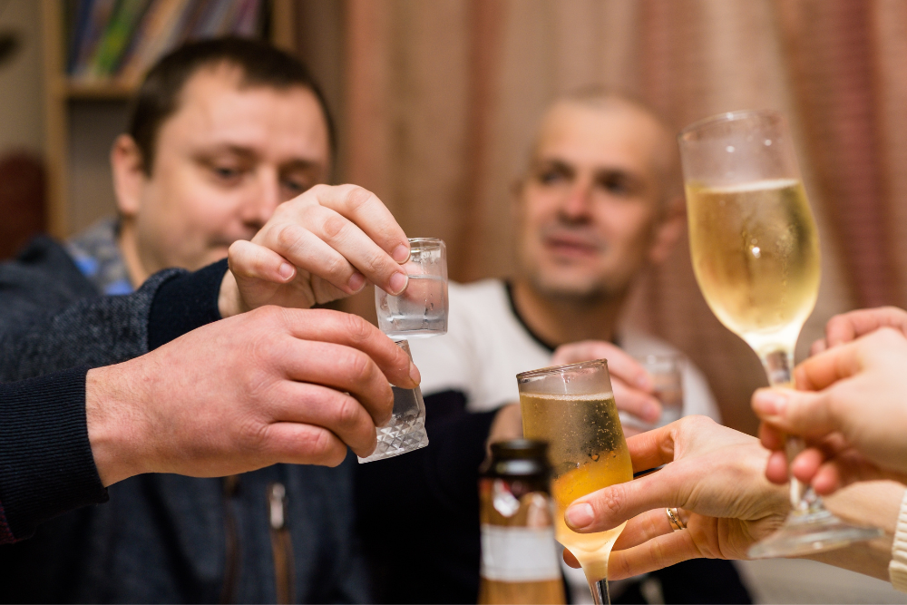 Men celebrating with glasses of alcohol, often is considered a gateway drug