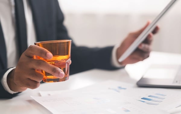 Image of man working with glass in hand as Avenues Recovery explores where to find the best non-alcoholic drinks and sober bars in Maryland