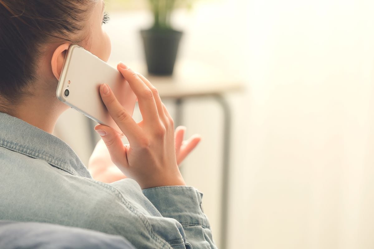 Image of woman talking on phone as Avenues Recovery explores Colorado drug and substance abuse hotlines