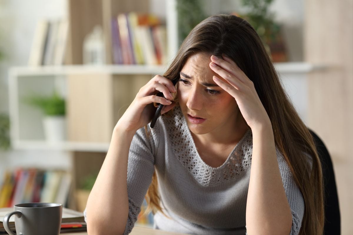 Image of distressed woman on phone as Avenues Recovery explores depression and addiction