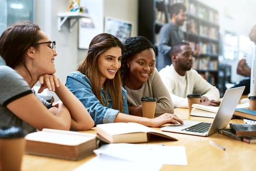 Image of college students smiling and studying together as Avenues Recovery explores "Is Ritalin addictive"?