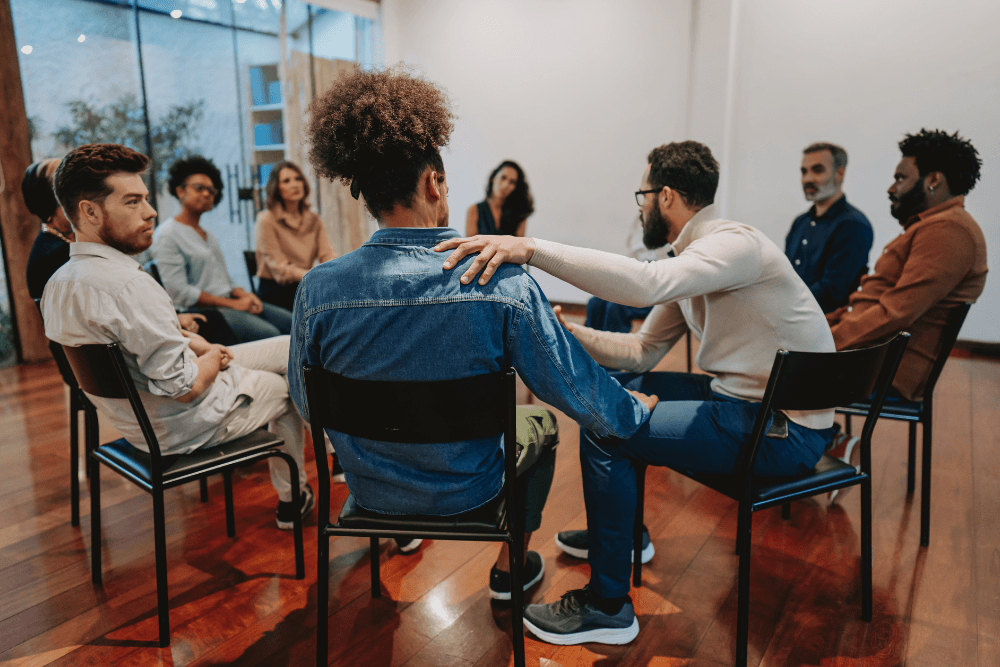 Group members supporting each other. Group support is one component of Ambien withdrawal treatment.