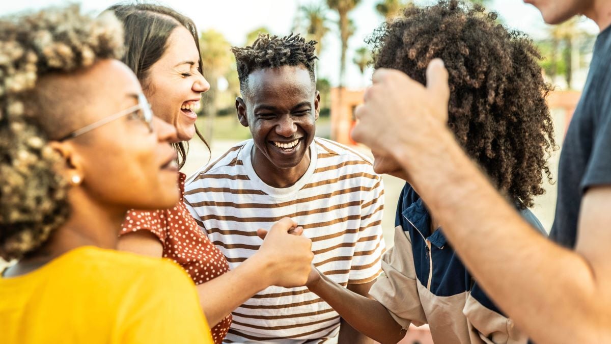 Image of people laughing together as Avenues Recovery explores peer pressure and drinking