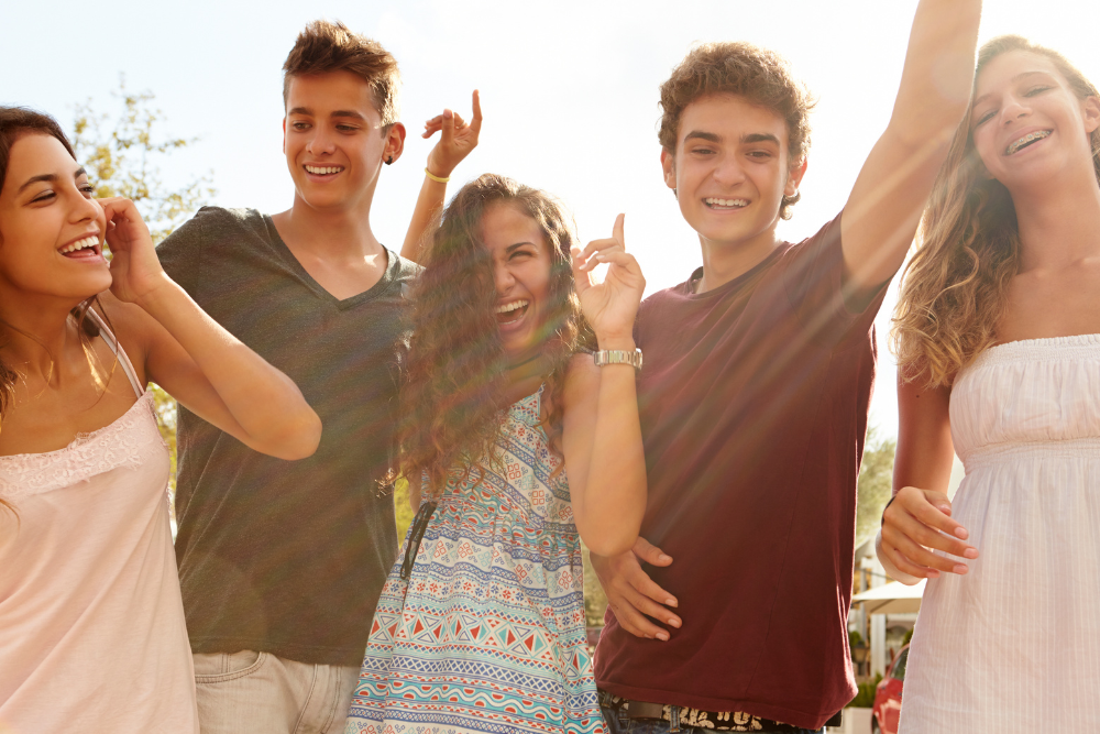 A group of teenagers laughing, illustrating how peer pressure can lead to tramadol misuse and addiction.