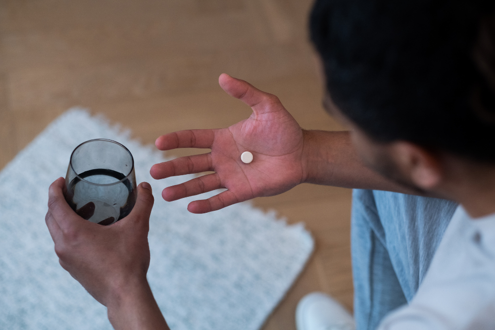 Man looking at a Flexeril pill in his hand, wondering if you can overdose on Flexeril