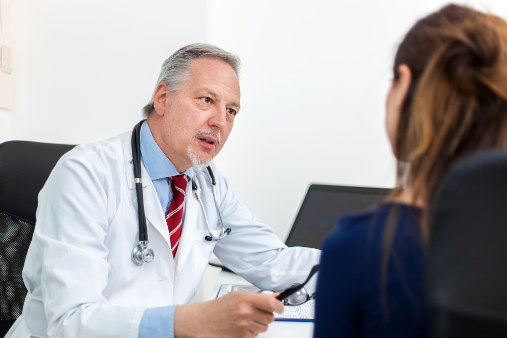 Woman sitting with a treatment provider, who is helping her choose a rehab facility